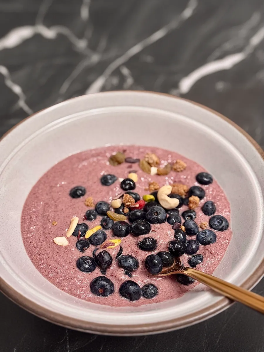 Nutty Pudding bowl topped with blueberries on marble