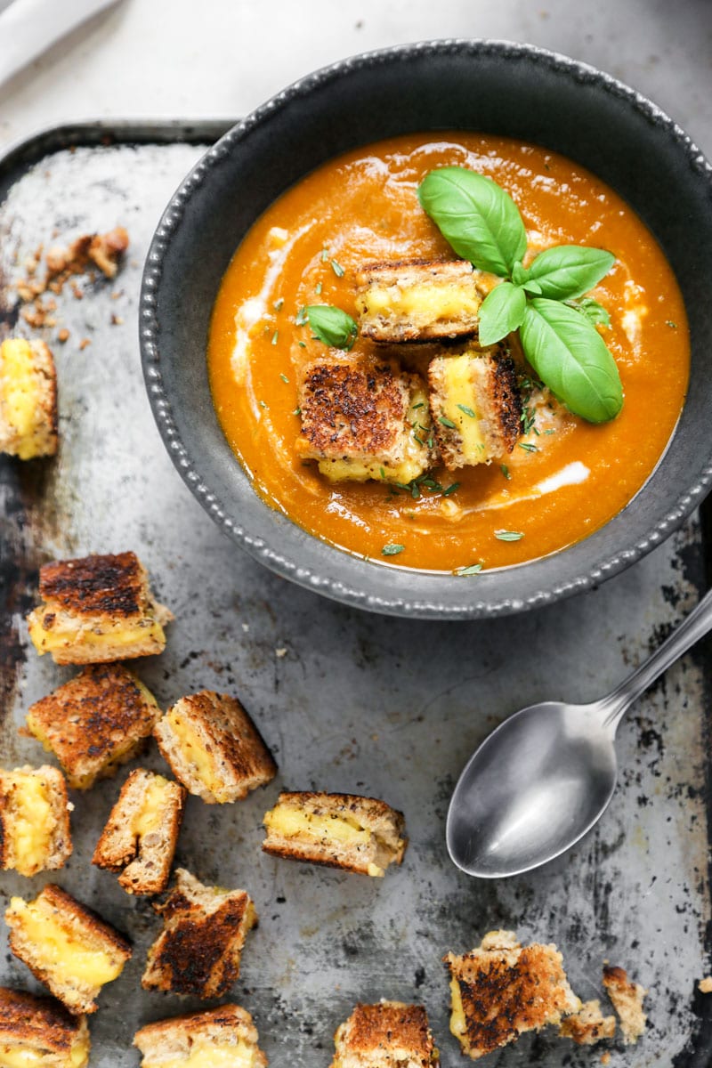 Tomato soup with basil, pesto, and croutons